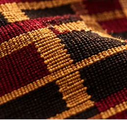 Rich burgundy, gold and black woven West African textile